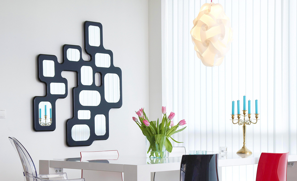 Lucio Wall Lamp is an evenly backlit frame of 12 mirrors creating a silhouette of a modern organic shape when it's dark